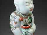 an image of a ceramic figurine of a man holding a potted plant
