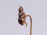 a picture of a gold plated figurine of a boy sitting on a flower