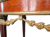 a wooden table with a gold decoration on it