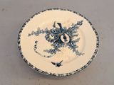 a blue and white plate with a clock on it
