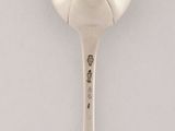 a spoon that is sitting on a white surface