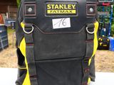 a black and yellow backpack with a name tag on it