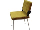 a yellow chair that is sitting on a white surface