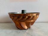 a metal bowl on a marble counter top