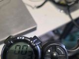 a close up of a bike handlebar with a digital clock on it