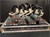 many different types of headphones sitting on a rack