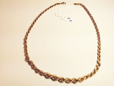 a close up of a necklace on a table with a white background