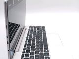 a white laptop with a black keyboard on a white surface