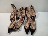 four pairs of black and gold shoes with pearls on them