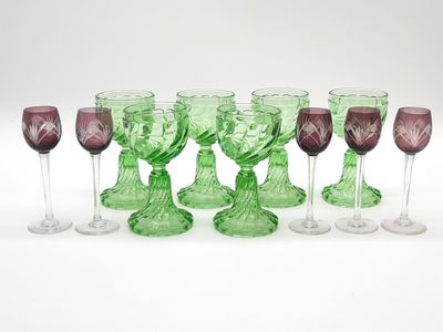 several wine glasses are lined up in a row on a white surface