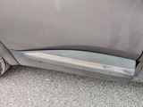 a close up of a car ' s door handle and the door handle of the car