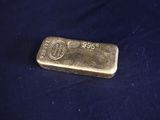 a gold bar sitting on top of a blue cloth