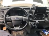a steering wheel and dashboard of a car with a phone in it