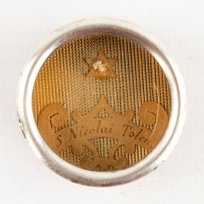 a close up view of a gold coin with a crown on it
