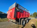 a red dump truck that is parked on the side of the road