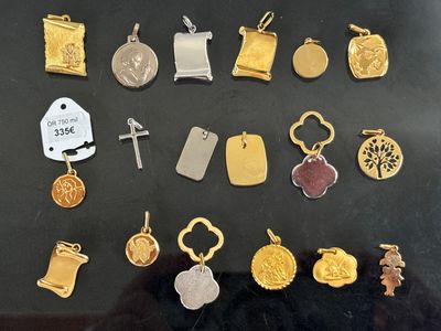 many different types of charms on display in a glass case