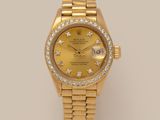 a lady ' s rolex watch with yellow dial and diamonds