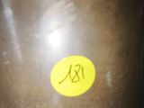 a brown pot with a yellow sticker on it