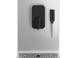 a close up of a coffee machine on a white surface