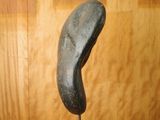 a sculpture of a shoe on a wooden stand