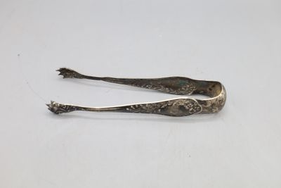 a pair of tonges sitting on a white surface