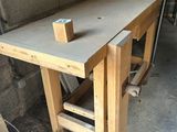 a workbench made of wood with a piece of wood sticking out of it