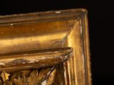 a close up of a gold frame with a black background