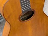a guitar that is sitting on the floor in front of a basket