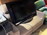 a television that is sitting on a couch in the living room