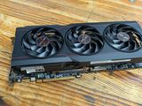 a close up of a video card sitting on top of a wooden table