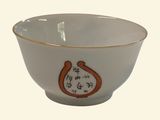 a white bowl with an orange design on it
