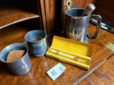 a wooden table with two cups and a box on it