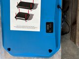 a blue box with a sign on it sitting on the floor
