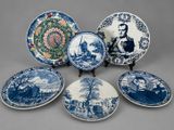 six blue and white plates with a picture of a man and a woman on them