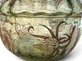 a green glass bowl with an octopus design on it
