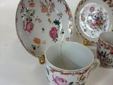 three cups and a saucer sitting on a table