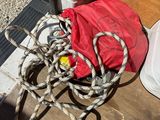 a red bag and some rope on the ground