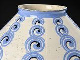 a blue and white vase on a black background