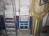 a room that has a ladder and a cart in it
