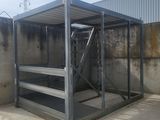 a large metal structure with a ladder in the middle of it