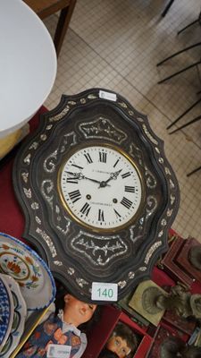 a table with a clock, plates and a bowl on it