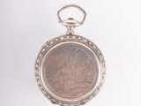 an image of a silver pocket watch with a picture of a woman on it