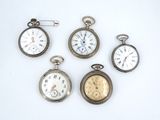 several different types of pocket watches are displayed on a white surface