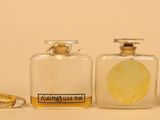 three bottles of perfume sitting next to each other on a table