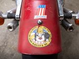 a close up of a red motorcycle with a sticker on it
