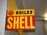 a sign that says hulls shell hanging from the ceiling