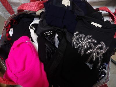 a suitcase full of clothes and a hat on the floor