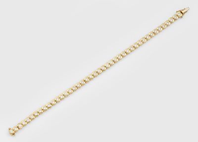 a gold chain bracelet with round links and a clasp