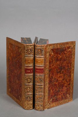 an old book opened to reveal a book with a bookmark in the middle
