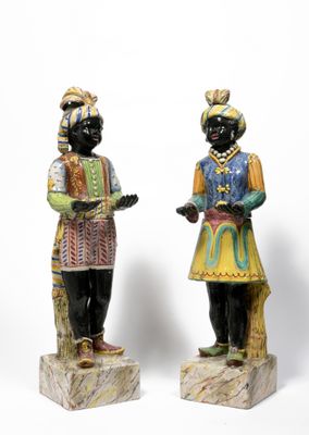 two figurines of a man and a woman standing next to each other